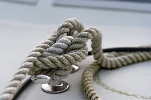 Free Closeup of strong mooring rope tied around steel anchor with nautical knot on modern yacht Stock Photo