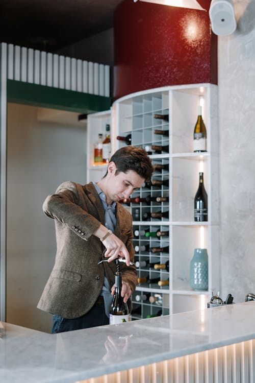 Man in Brown Coat Holding Bottle