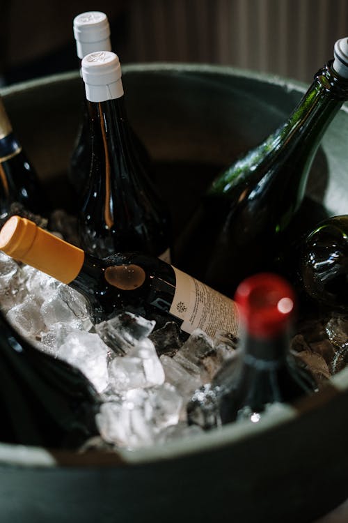 Wine Bottle on Ice on Clear Glass Bowl