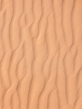 Close-up of textured sand dunes, capturing natural patterns and ripples. Perfect for nature and texture themes.