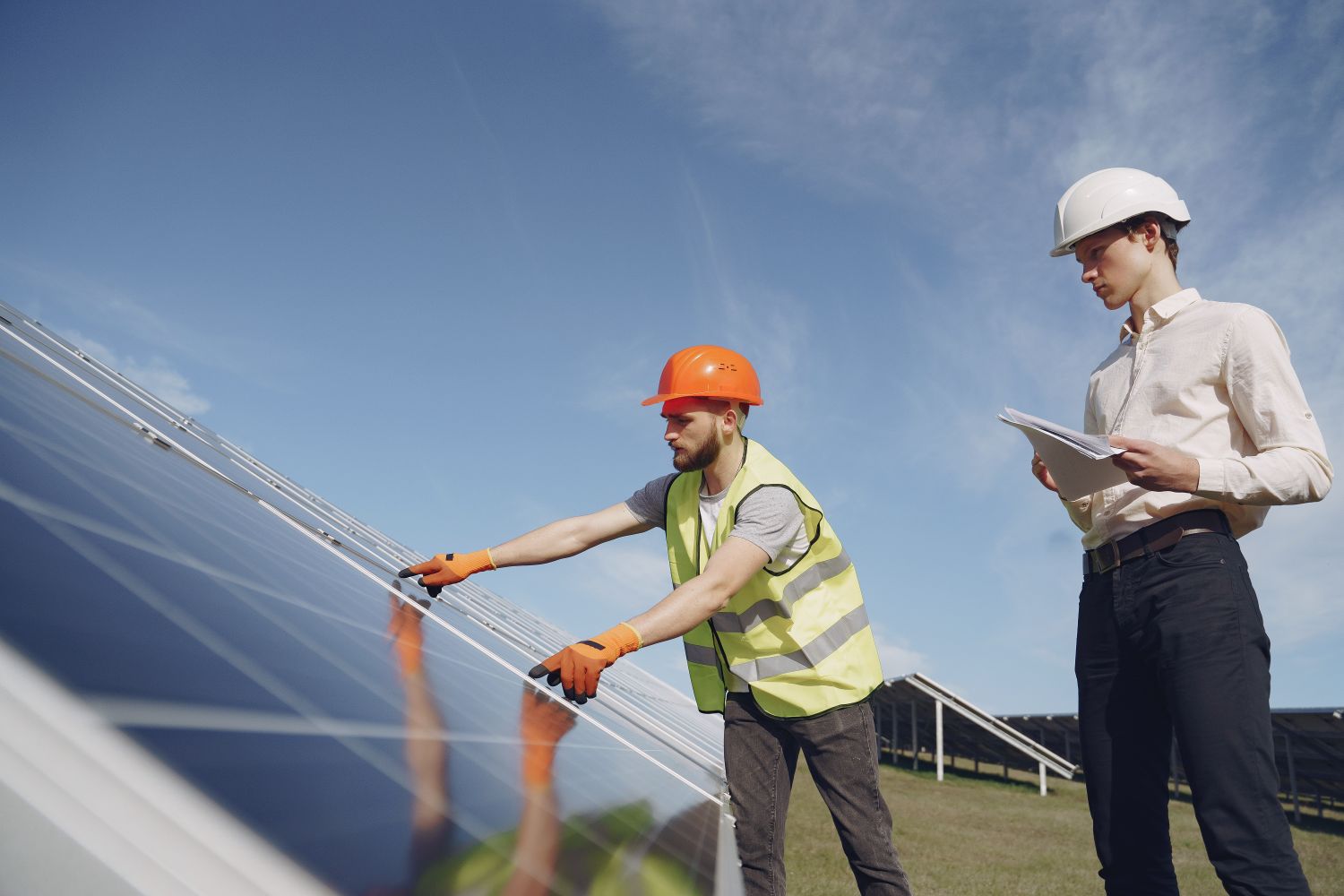 Engineers inspecting a solar photovoltaic installation before commissioning