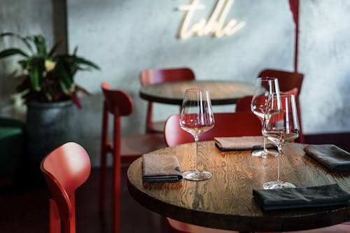 Clear Wine Glasses on Brown Wooden Table