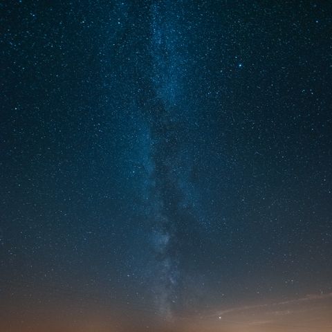 The Milky Way arcing over a dark shoreline — Grafixart_photo Samir BELHAMRA on Pexels