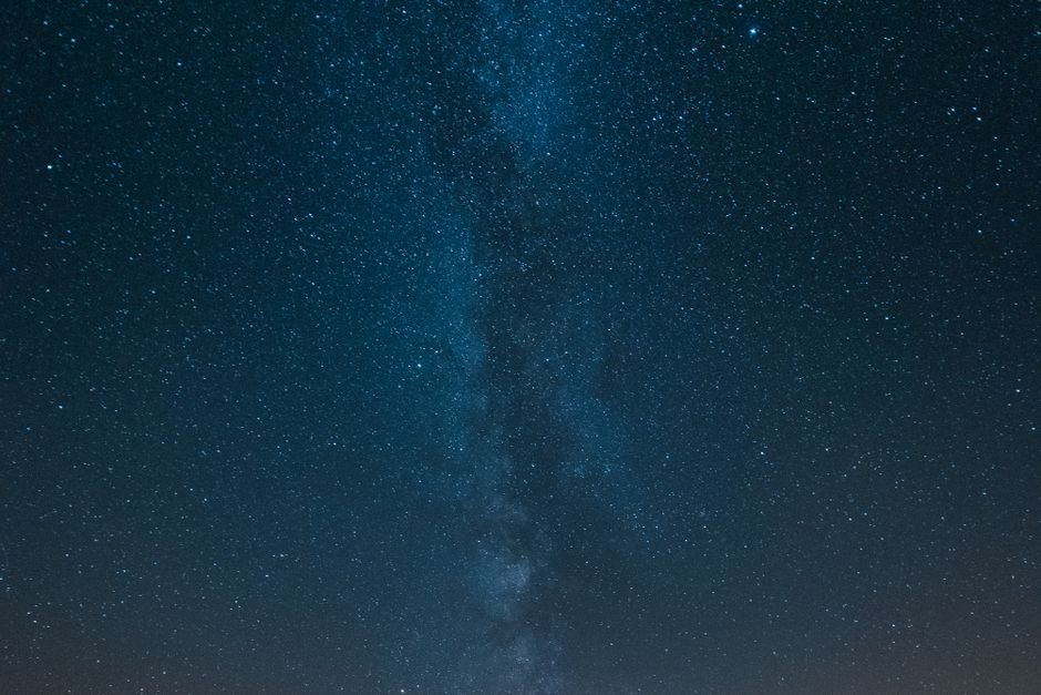 A vast starry night sky with the Milky Way stretching across the horizon — representing the sense of oceanic boundlessness and dissolution of individual self described by those who have undergone the bufo 5-MeO-DMT experience