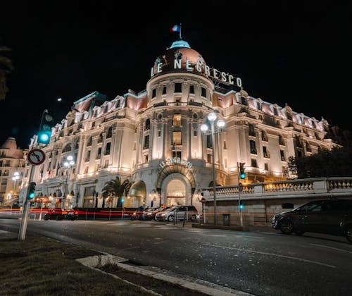 Facade of stylish illuminated aged building at night