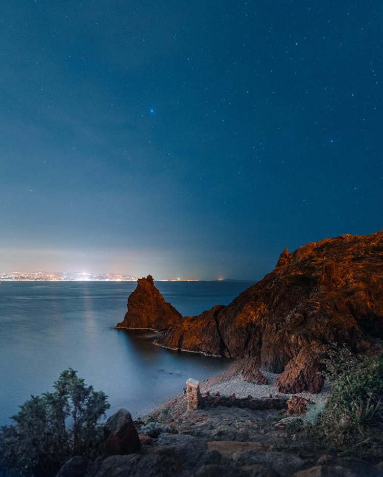 Rocky Ocean Coast Against Starry Sky