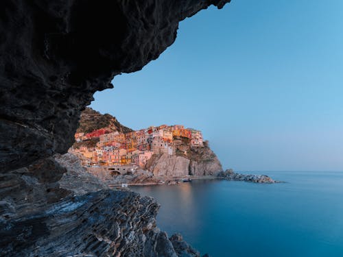 View on magnificent coastal town with colorful buildings from sea cave