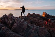 Tourist in black clothes standing on cliff