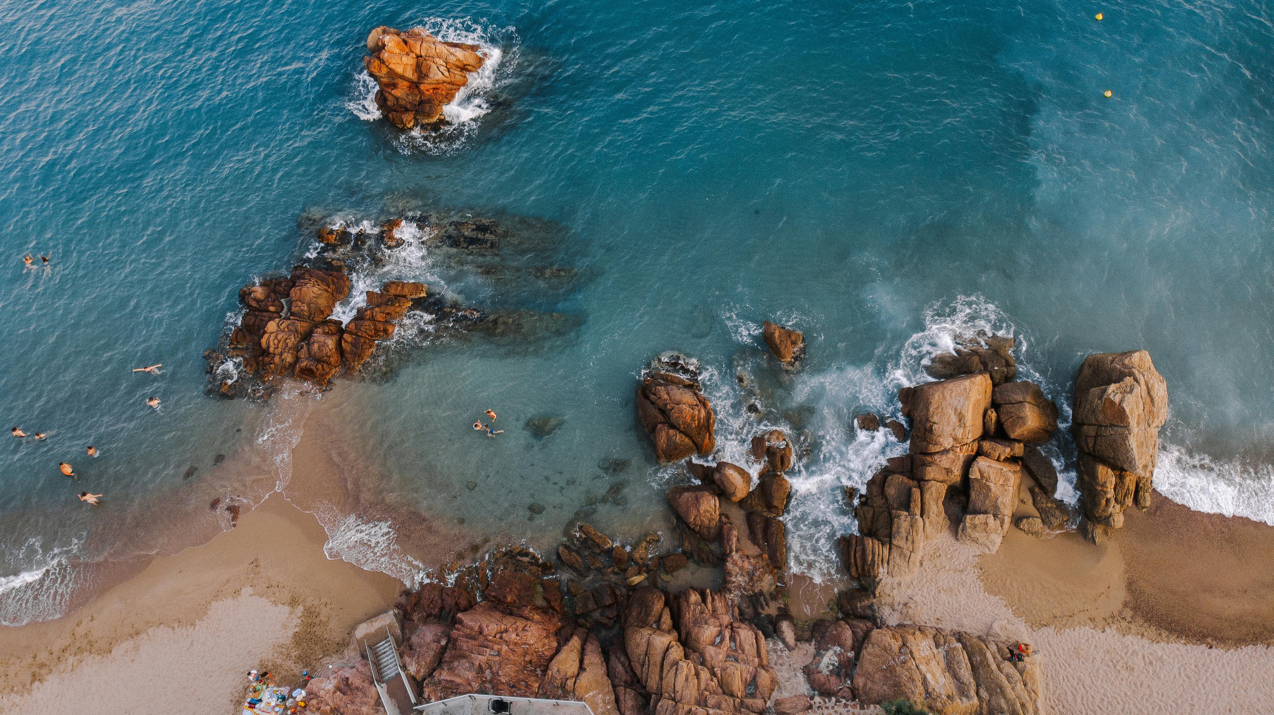 sandy coast with cliffs and blue water