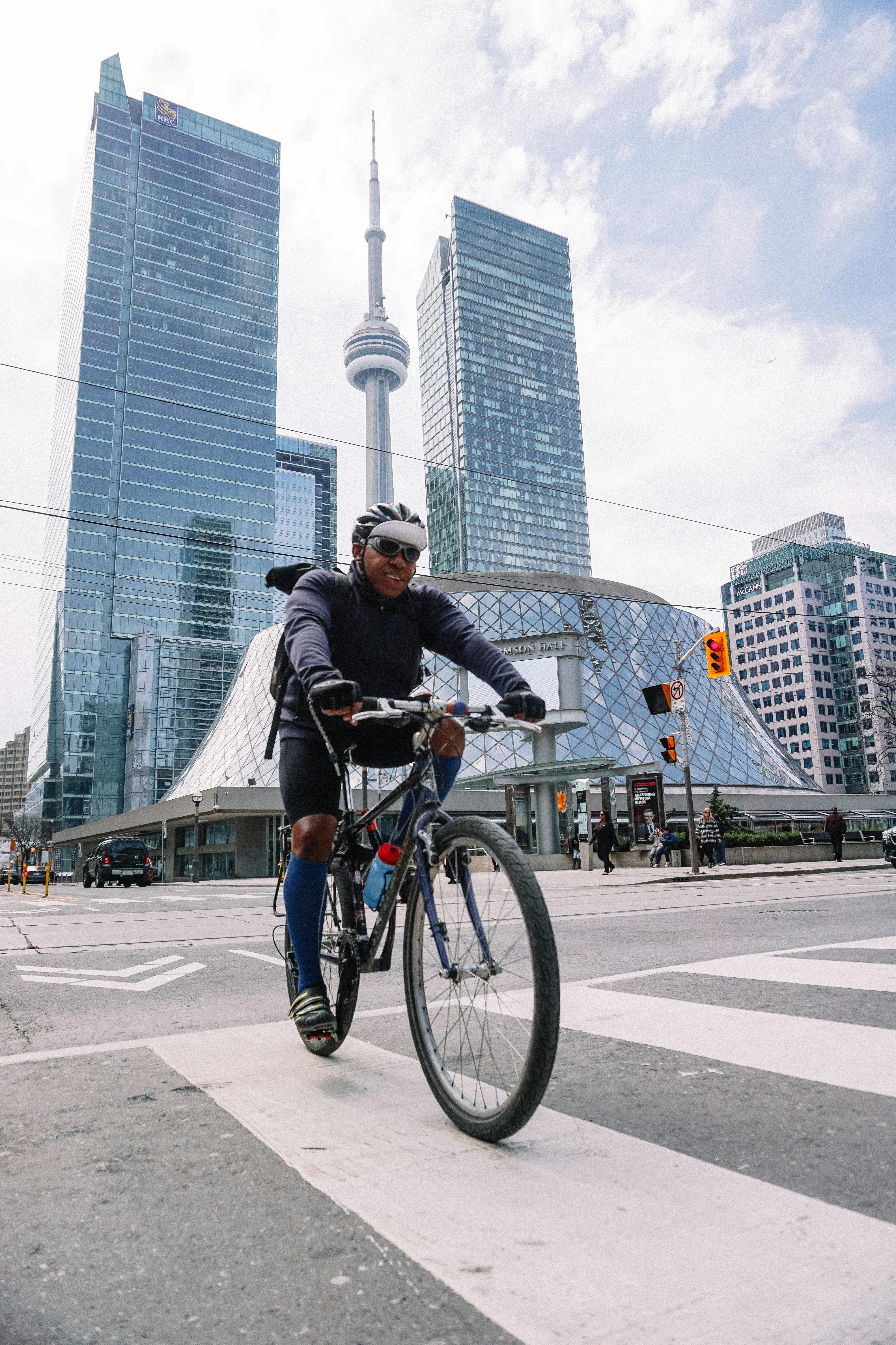 smiling professional cyclist riding in megapolis