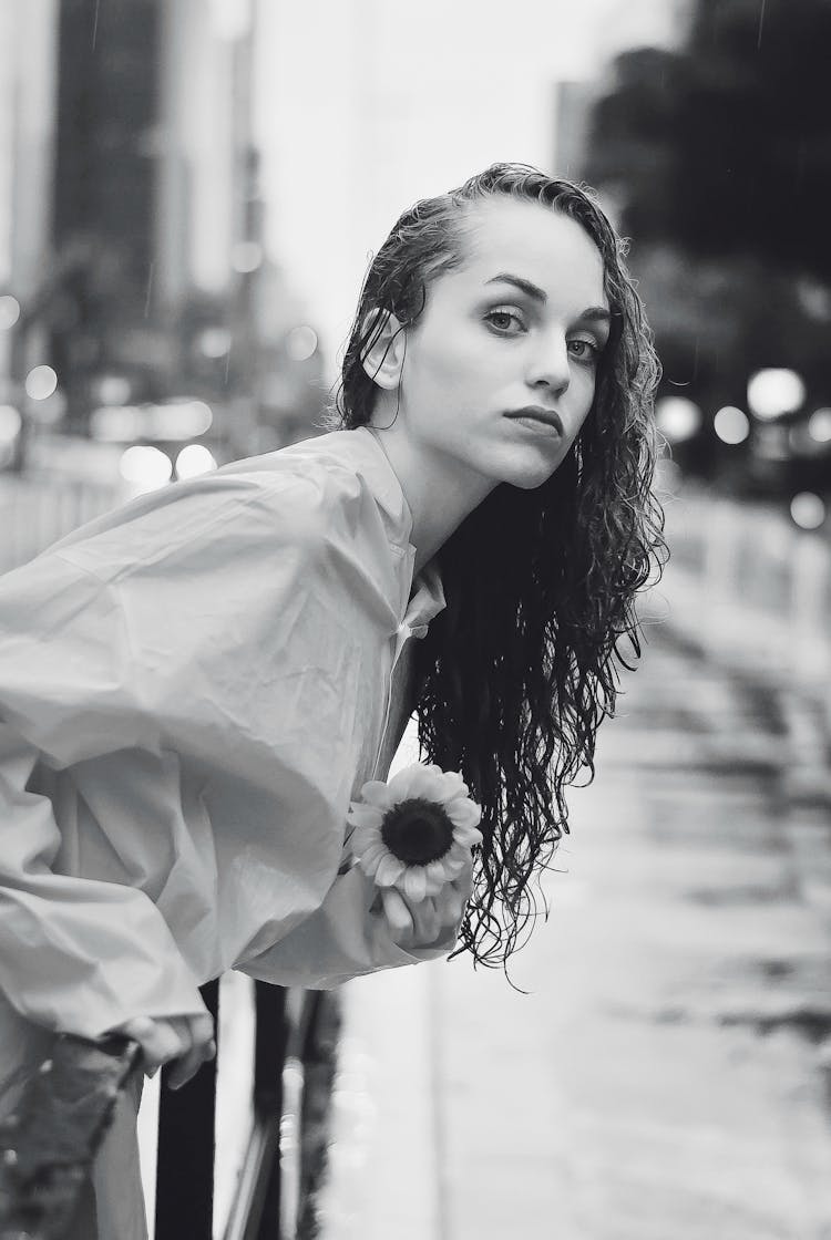 Wet Woman With Flower In Rainy City