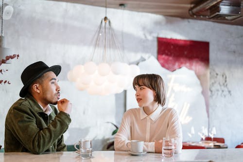 Free Man and Woman Sitting at Table Stock Photo