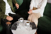 Man in White Dress Shirt Sitting on Chair