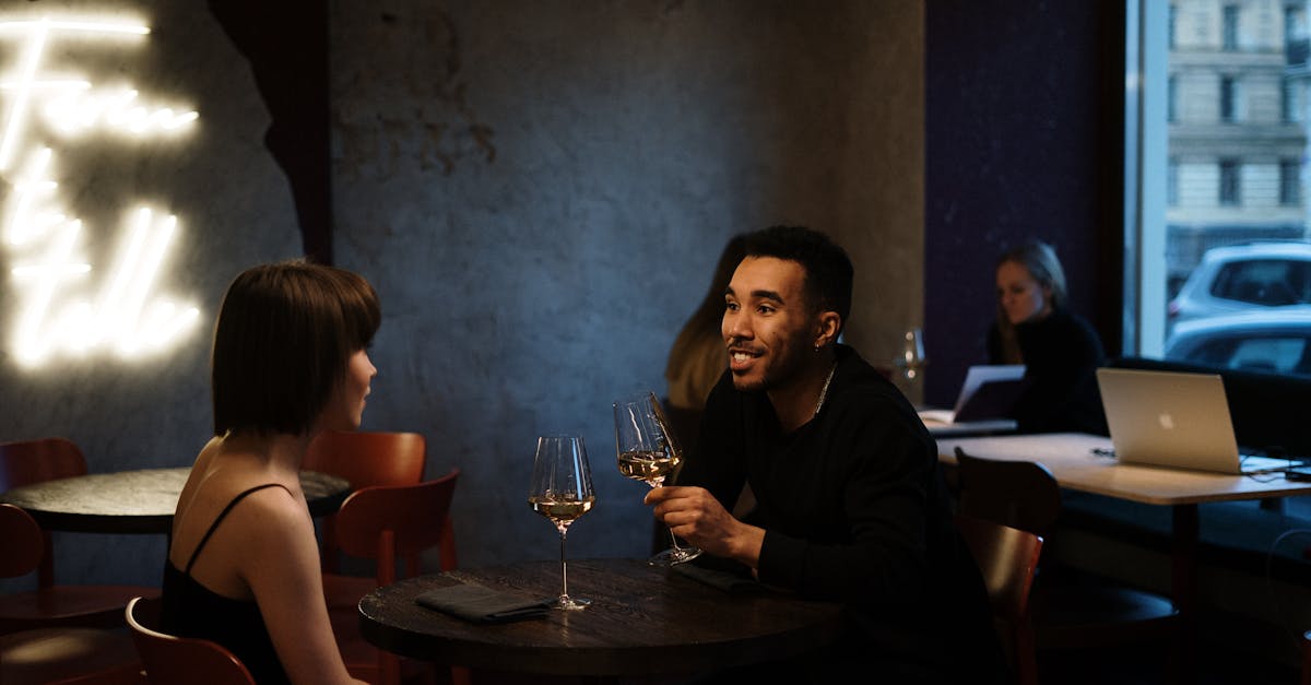 Couple enjoying a romantic evening with wine at a stylish bistro.