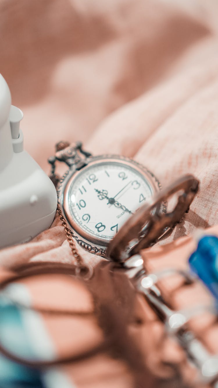 Old Fashioned Pocket Watch On Crumpled Sheet At Home