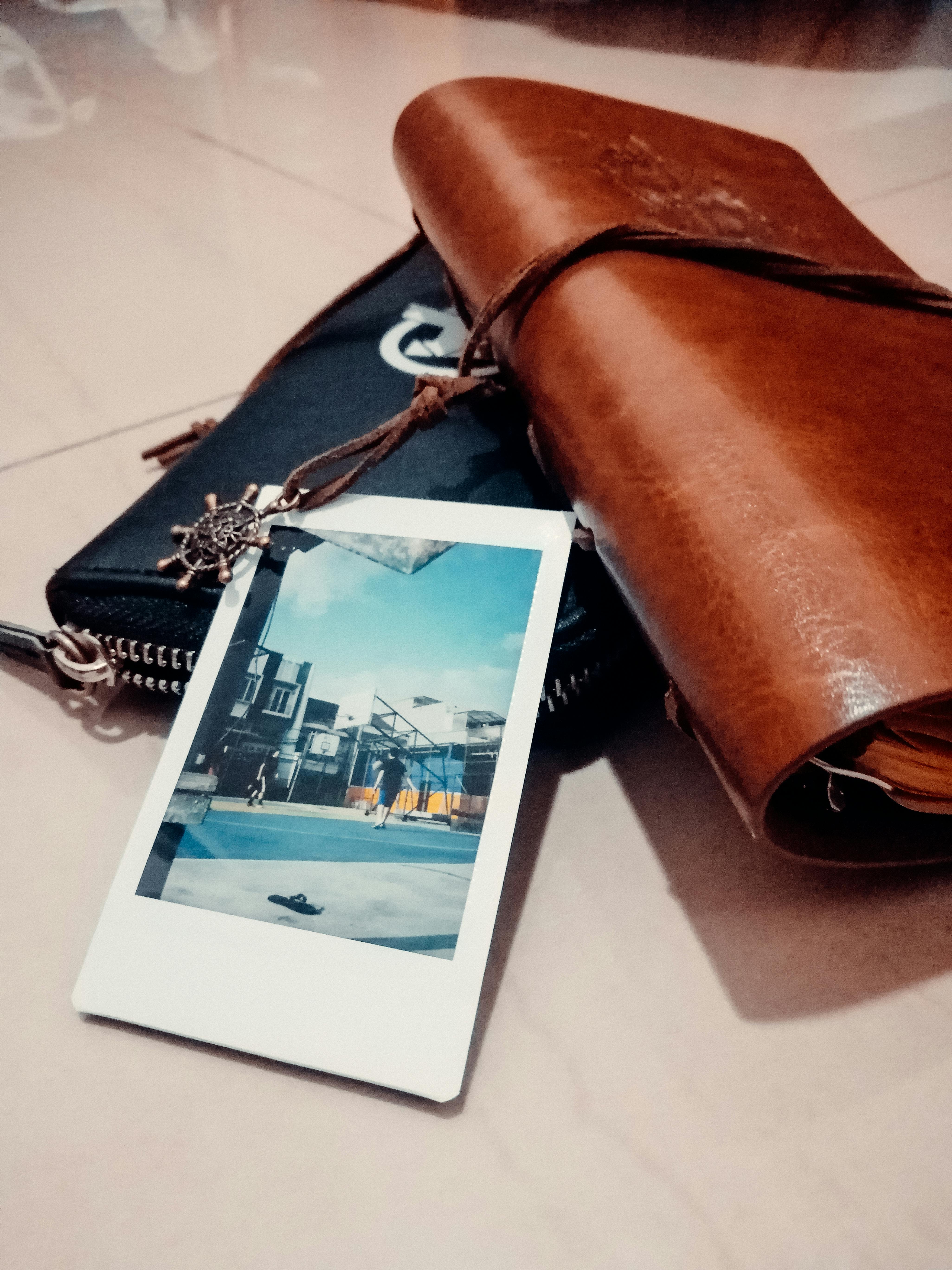 handbags with postcard on table in flat