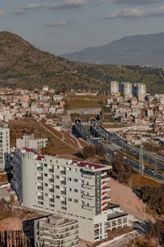 Aerial view of a residential area in Istanbul, showcasing modern architecture and surrounding landscapes.