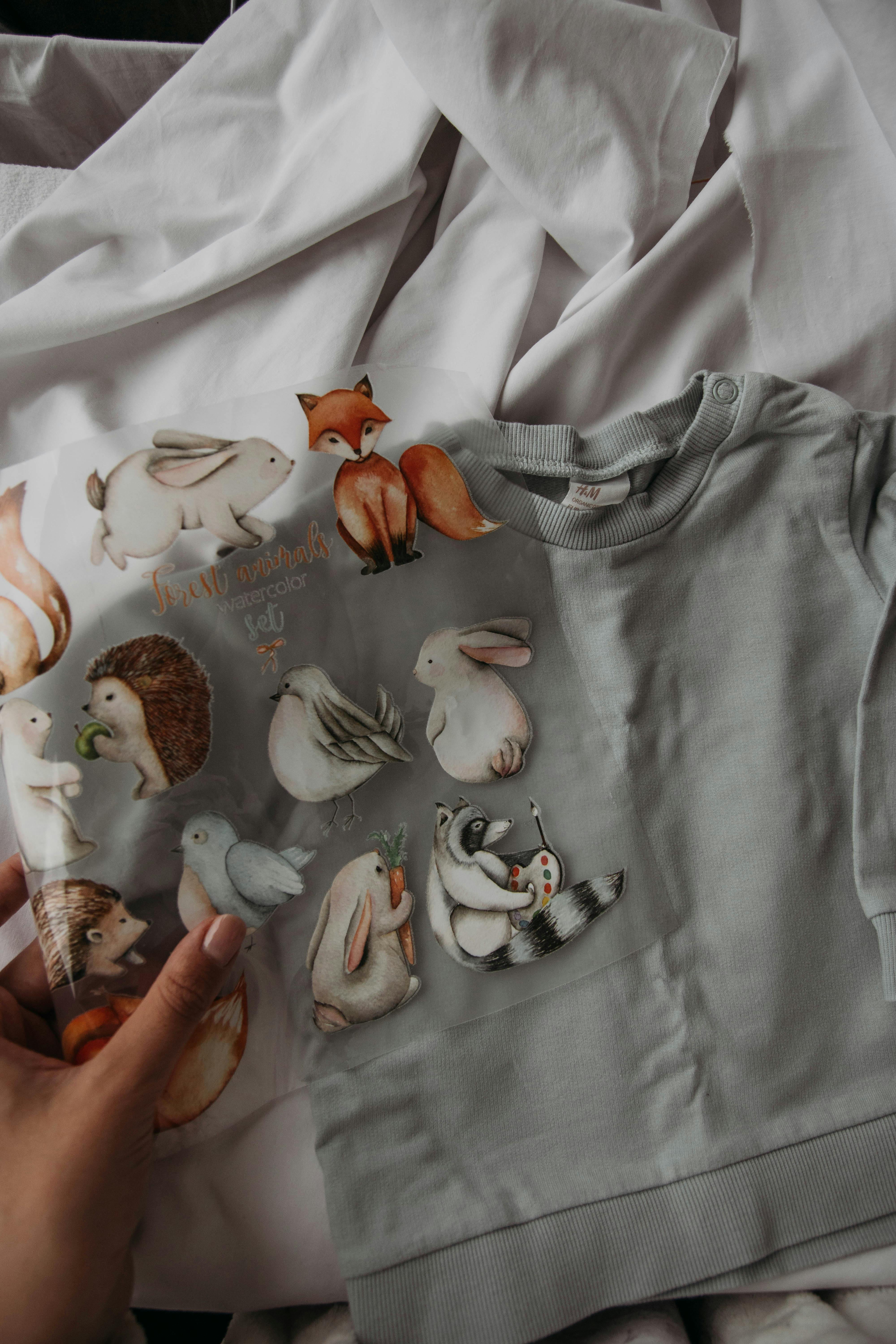 crop craftswoman with sheet of animal appliques and t shirt