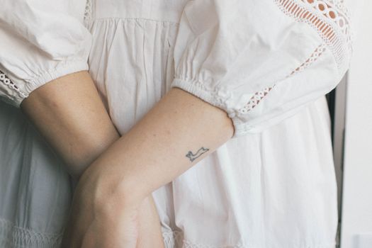 Crop woman in white linen dress with embroidery