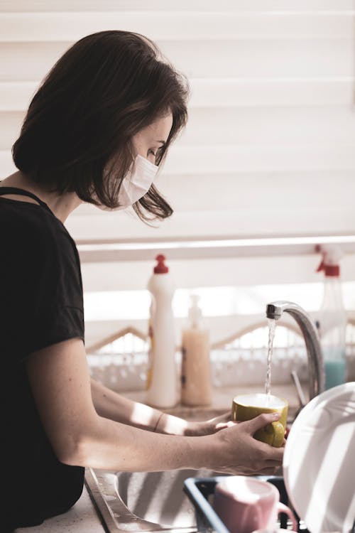 Free 
A Woman Getting Water from a Faucet Stock Photo