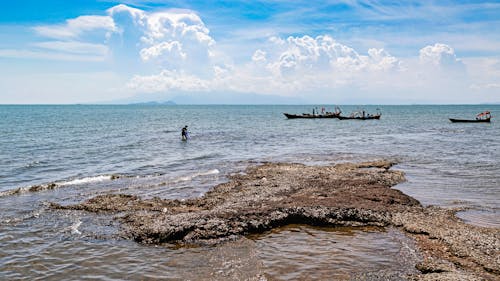 
Boats by a Rocky Shore