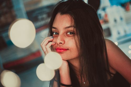 Free Enchanting portrait of a woman with bokeh lights in the background, highlighting her natural beauty. Stock Photo