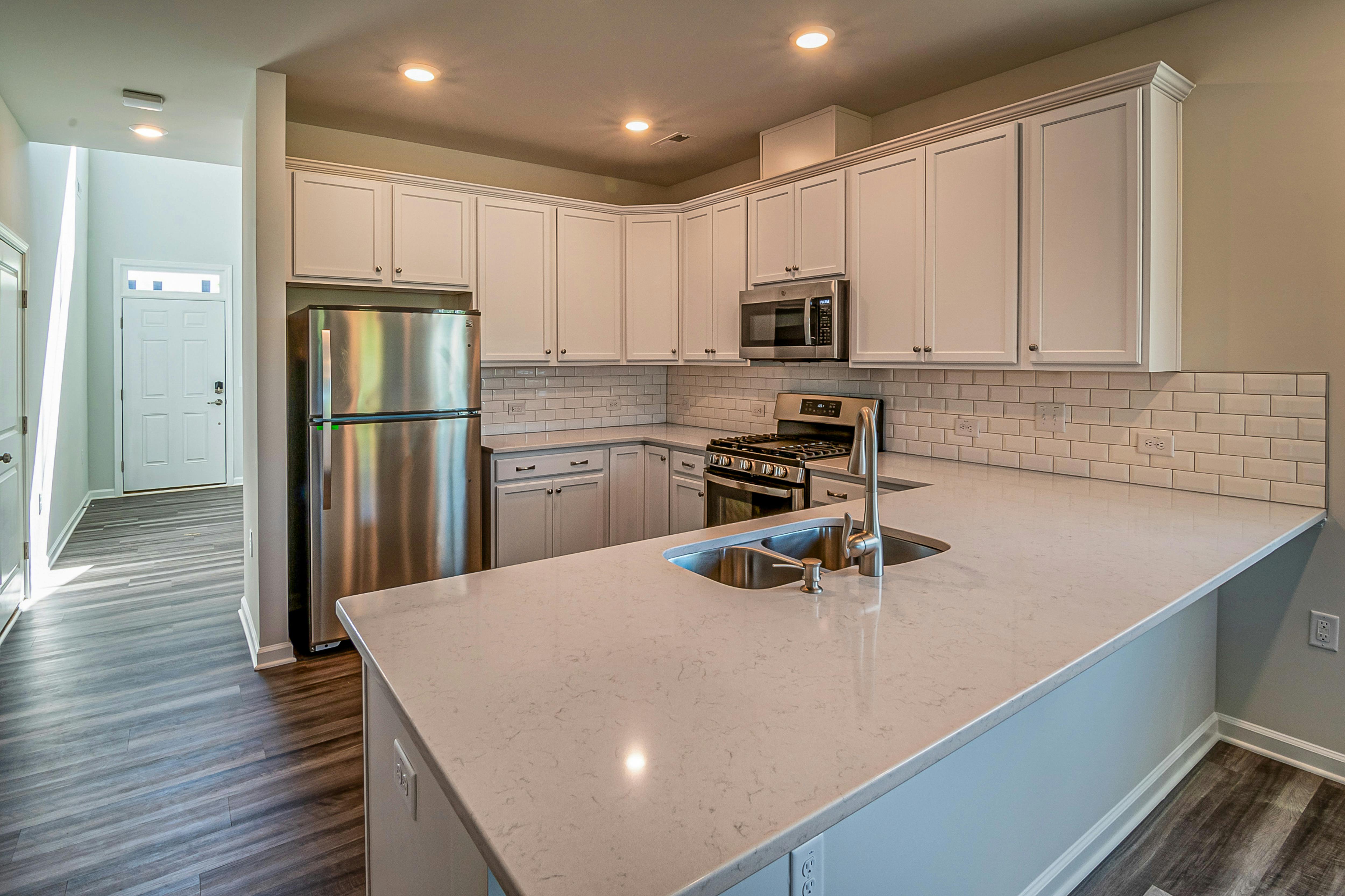 Free Contemporary kitchen featuring stainless steel appliances and a spacious countertop. Stock Photo