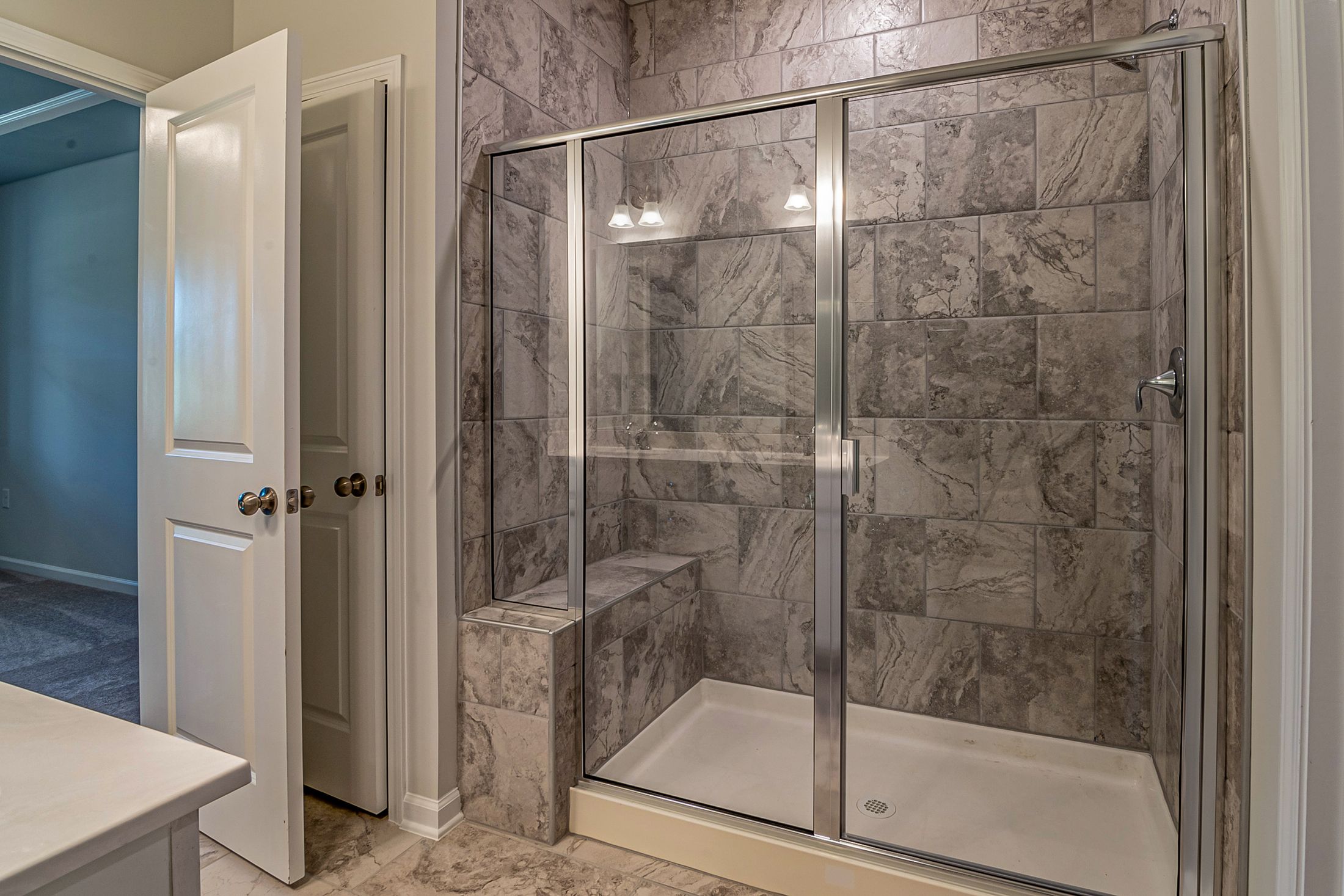 Modern bathroom with custom frameless glass shower enclosure