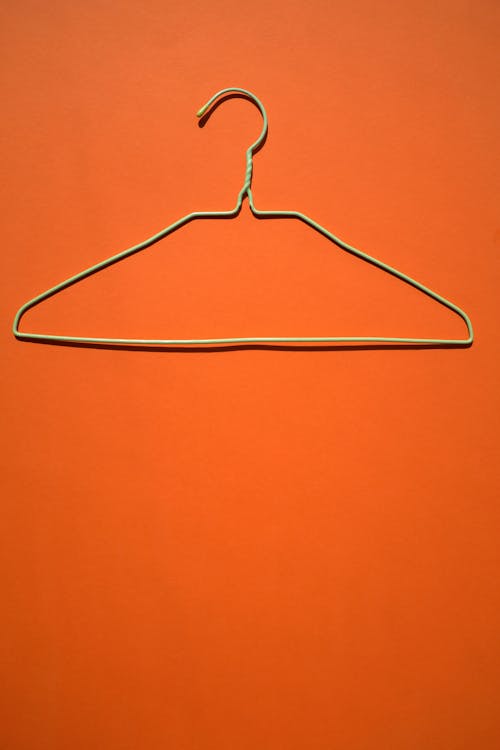 A Clothes Hanger on Orange Surface