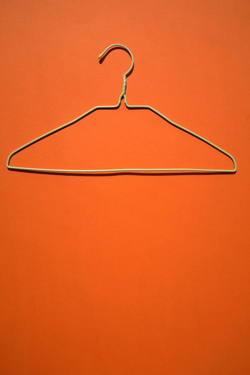 A Clothes Hanger on Orange Surface