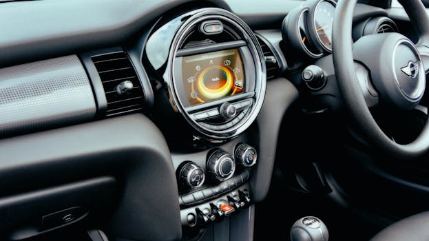 Close-up view of a Mini Cooper's dashboard interior, featuring modern controls and sleek design.