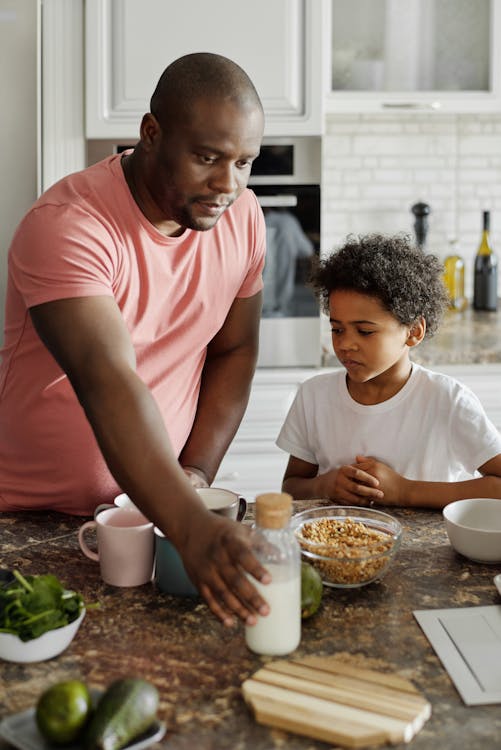 Free Father Making Breakfast for his Son Stock Photo