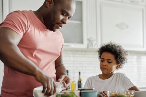 Free Father Making Breakfast for his Son Stock Photo