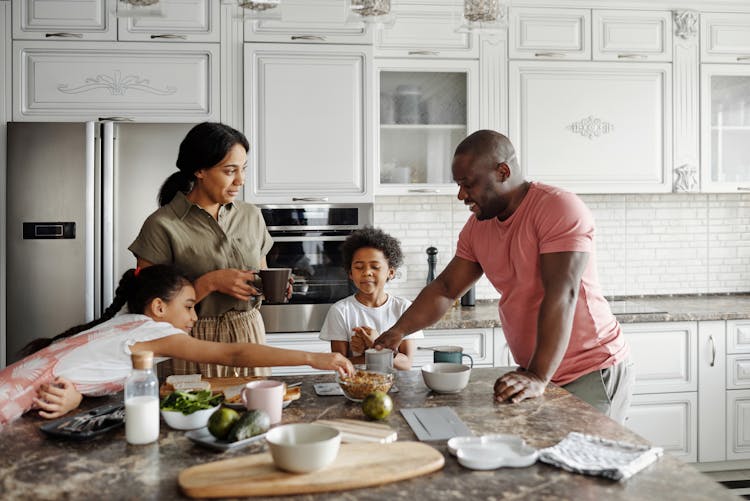 Family Making Breakfast In The Kitchen