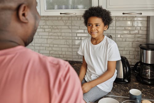 Little Boy Looking at his Father and Smiling