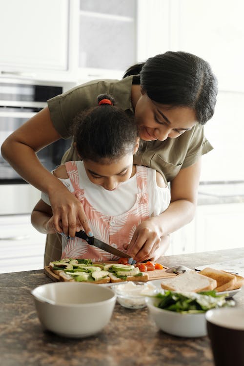 Free Mother teaching her Daughter how to use a Knife Stock Photo