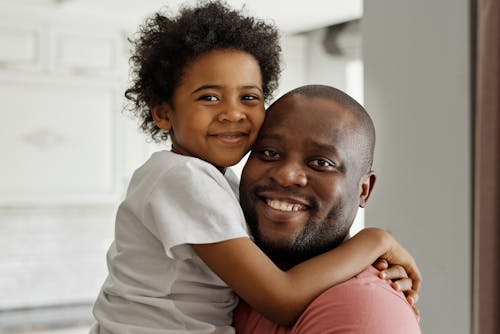 Free Father and Son Smiling and Looking at the Camera Stock Photo