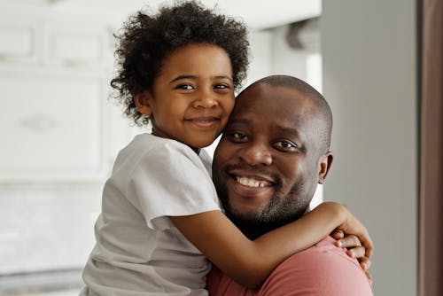 Father and Son Smiling and Looking at the Camera