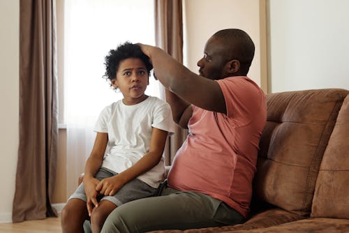 Father Brushing his Son's Hair