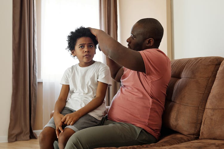 Father Brushing His Son's Hair