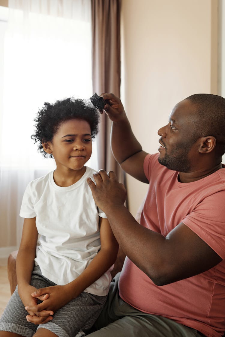 Father Brushing His Son's Hair