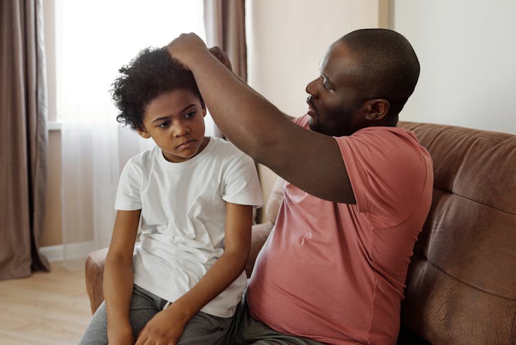 Father Brushing His Son's Hair