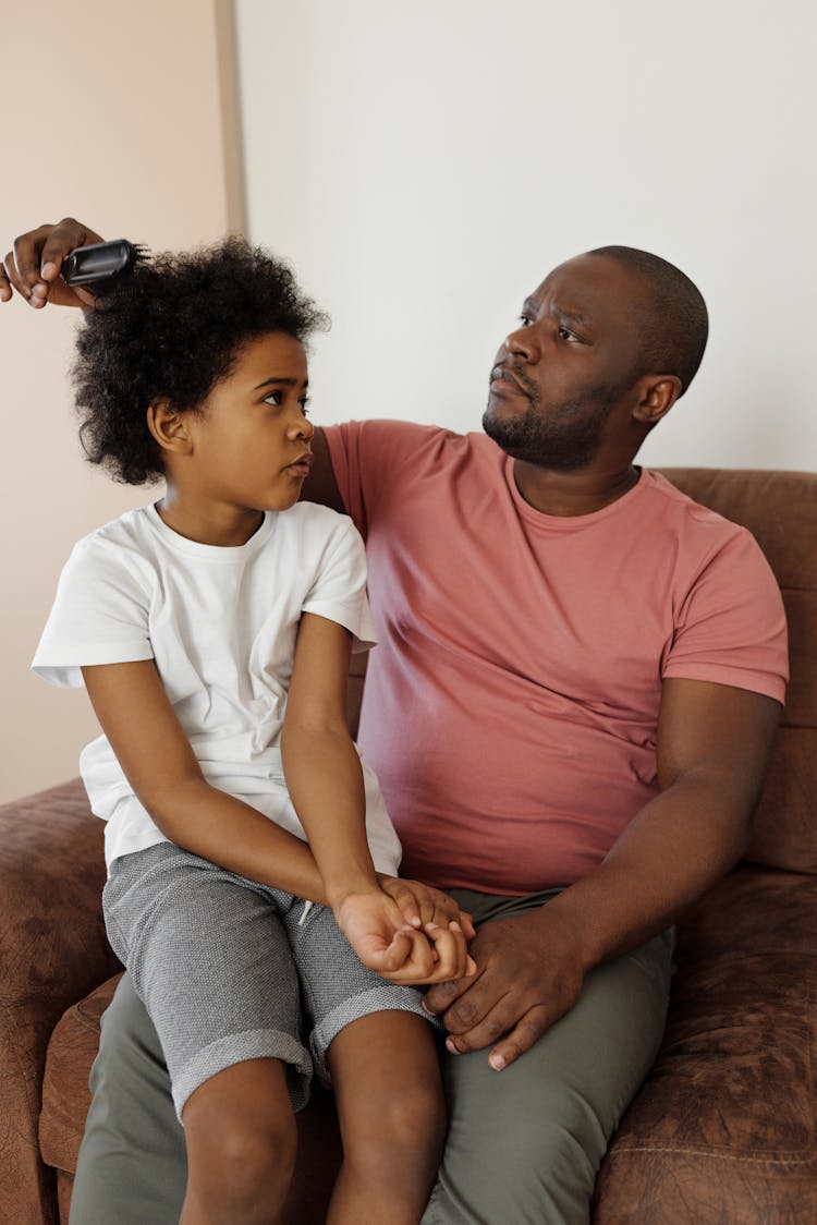 Father Brushing His Son's Hair