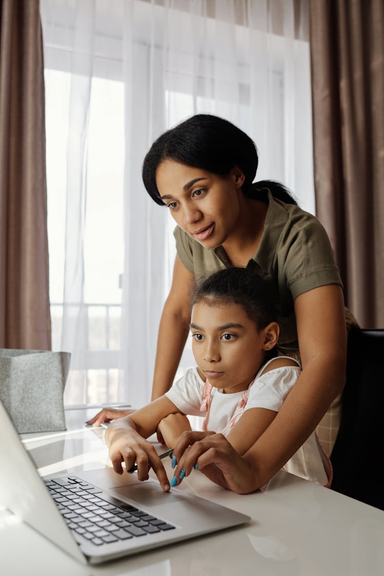 Mother Helping Her Daughter With Homework