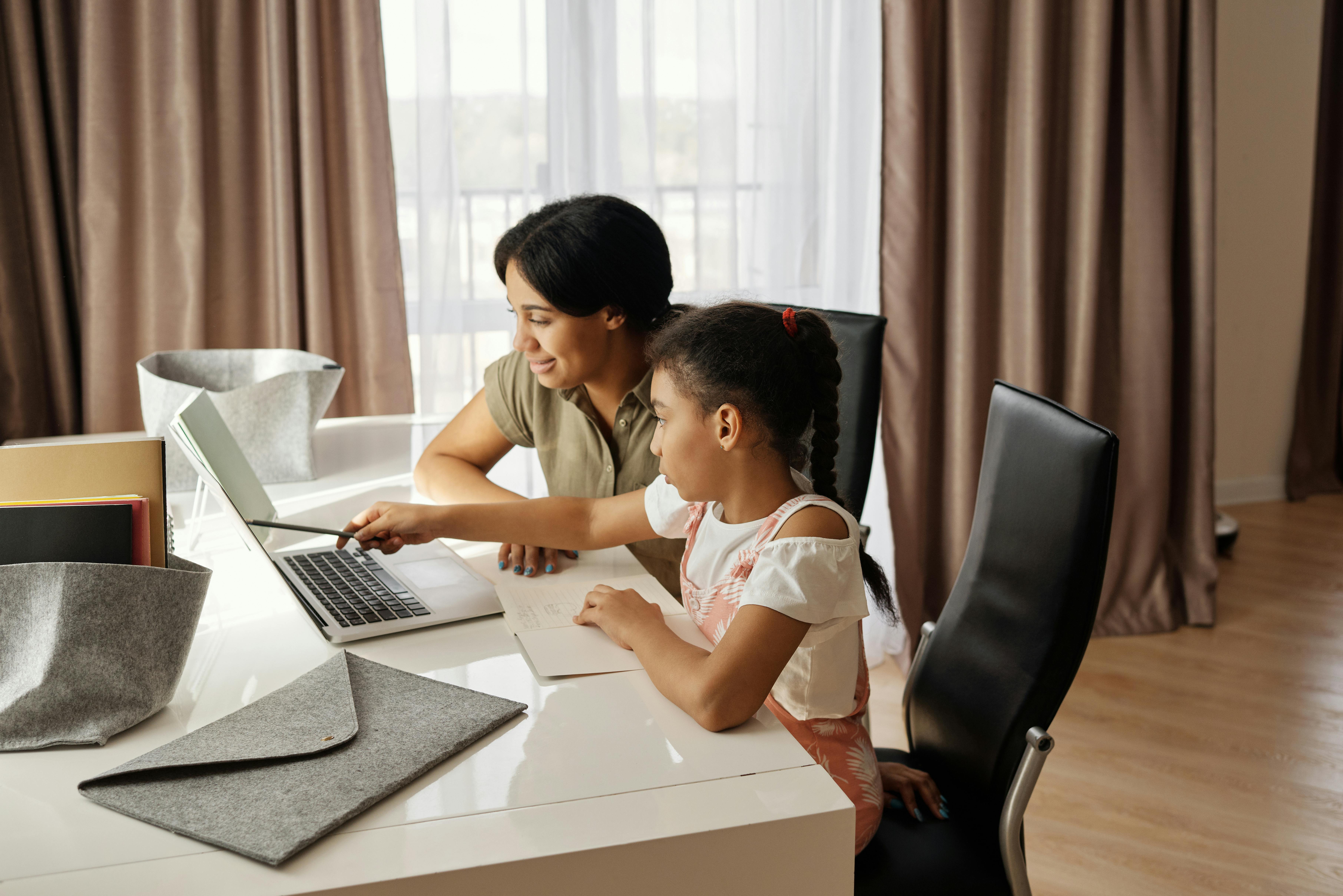 mother helping her daughter with her homework