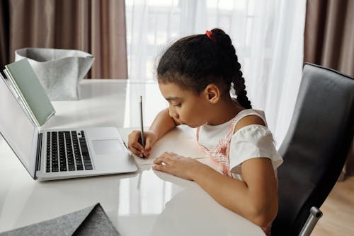 Free Little Girl Doing her Homework Stock Photo