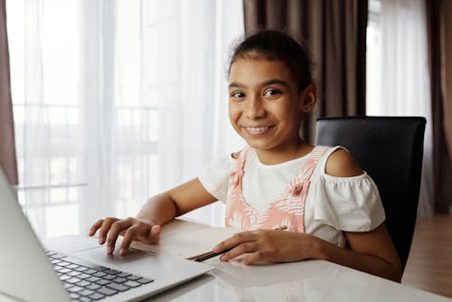 Free Young Girl Using a Laptop Stock Photo