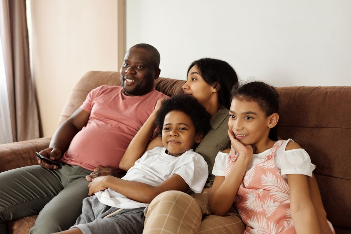 Family watching TV together at home