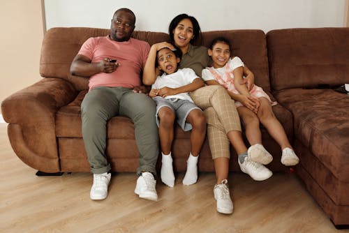 Family Sitting on a Brown Couch