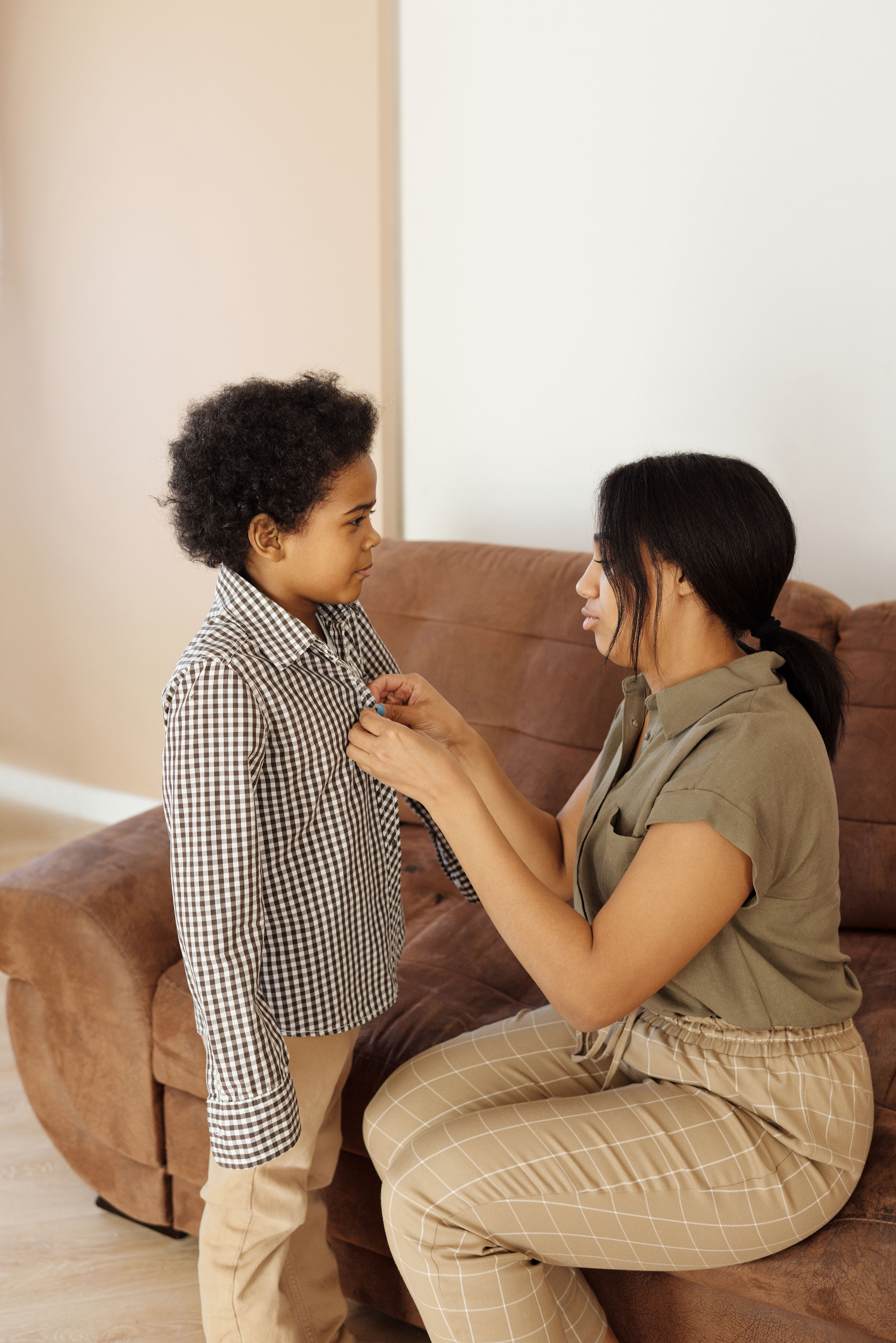 mother-helping-her-son-to-get-changed-free-stock-photo
